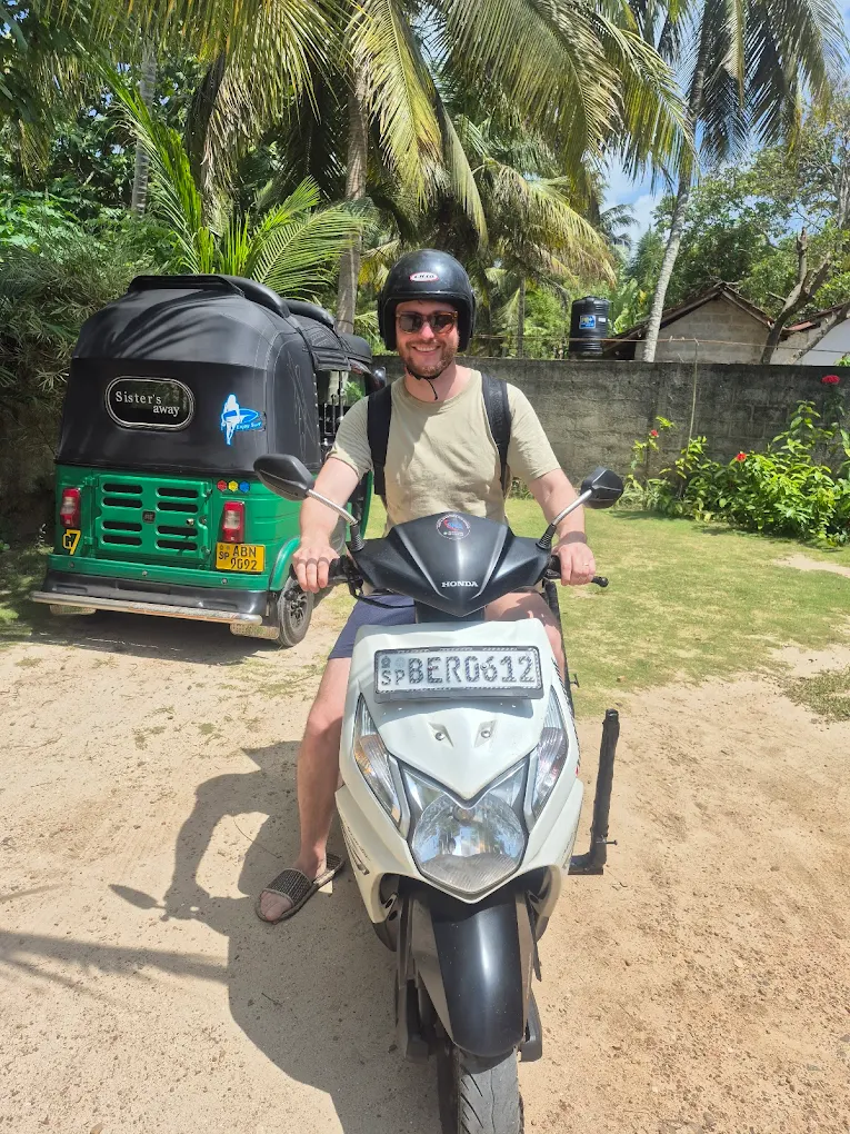 Tourist exploring the coast on a scooter with palm trees